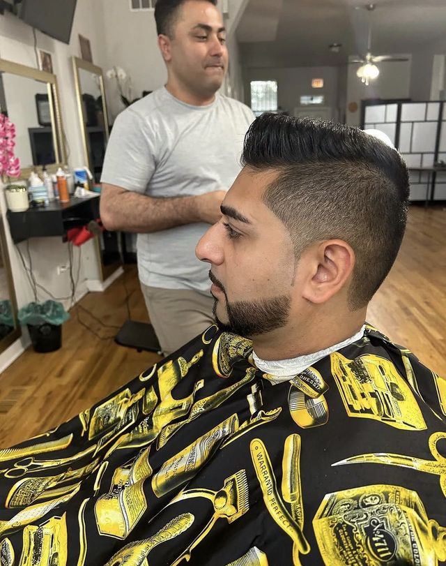 Barber giving a taper haircut at Masih.