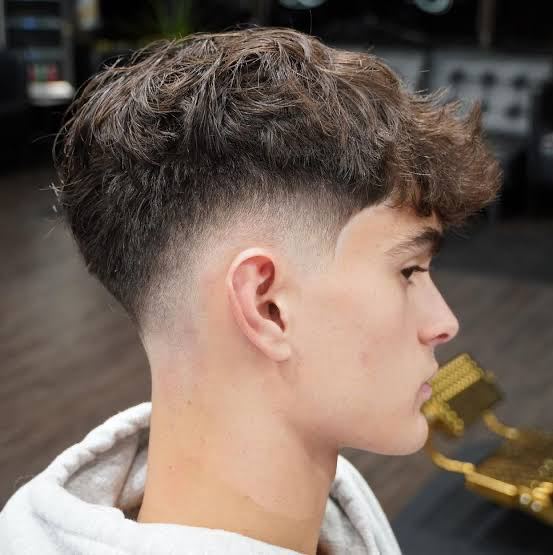Textured fringe fade haircut at Masih.