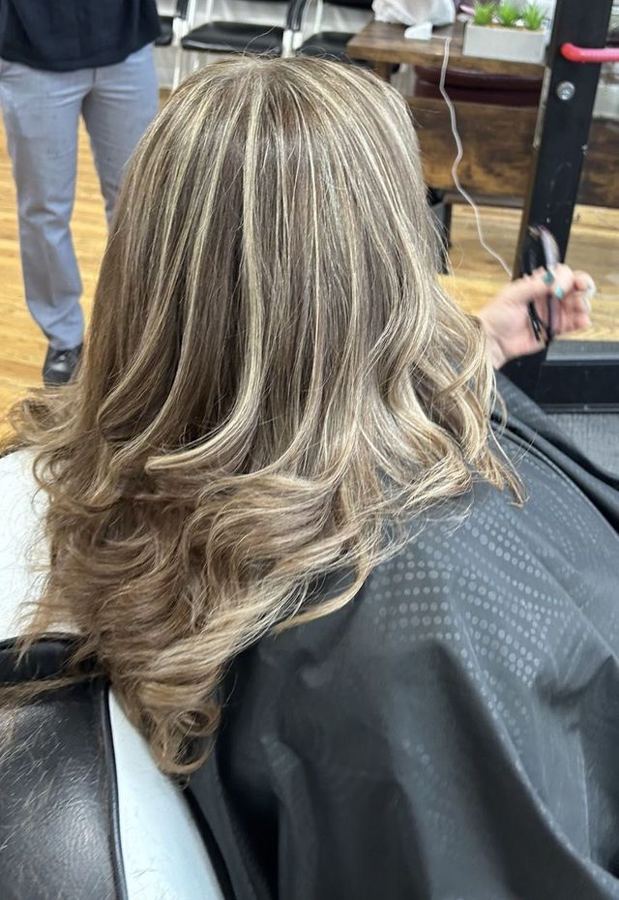 Blonde highlight color and curls at Masih.